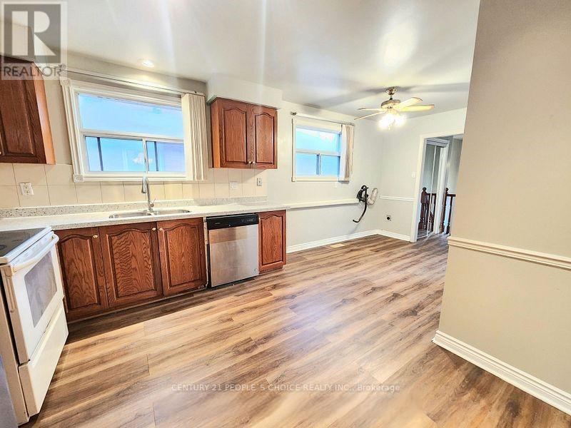 A kitchen with wooden cabinets and a white stove top oven.