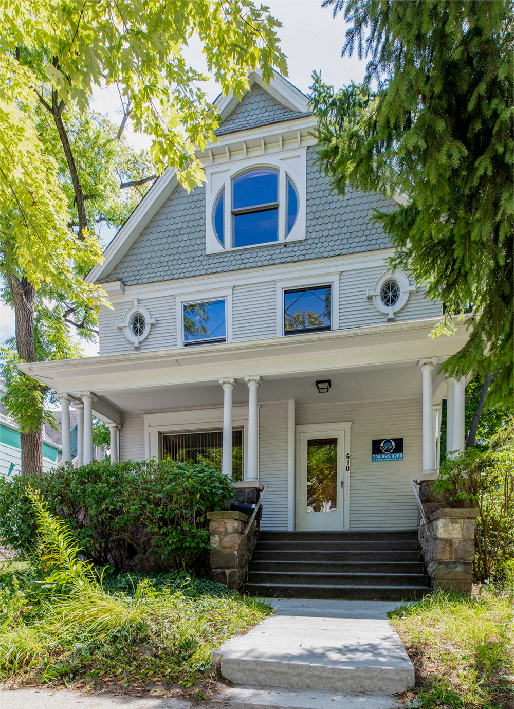 a house with a blue roof and a porch