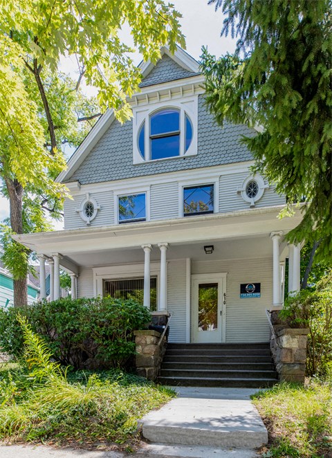 a house with a blue roof and a porch