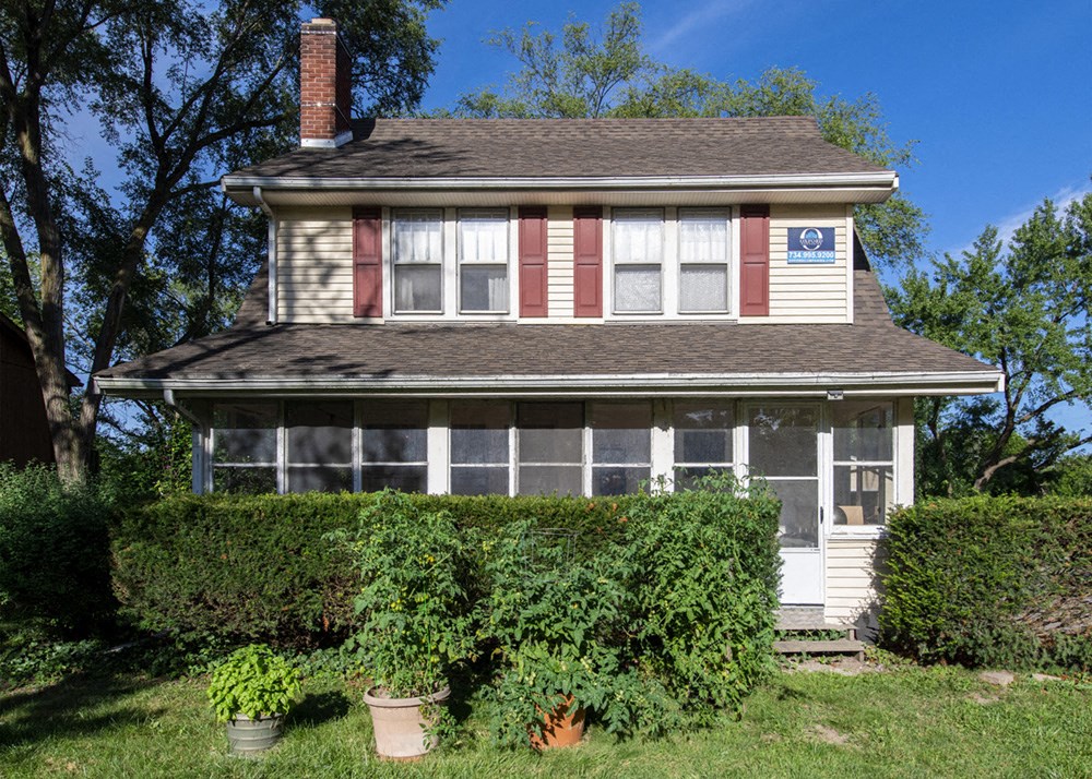 A house with a red stripe on the front wall.