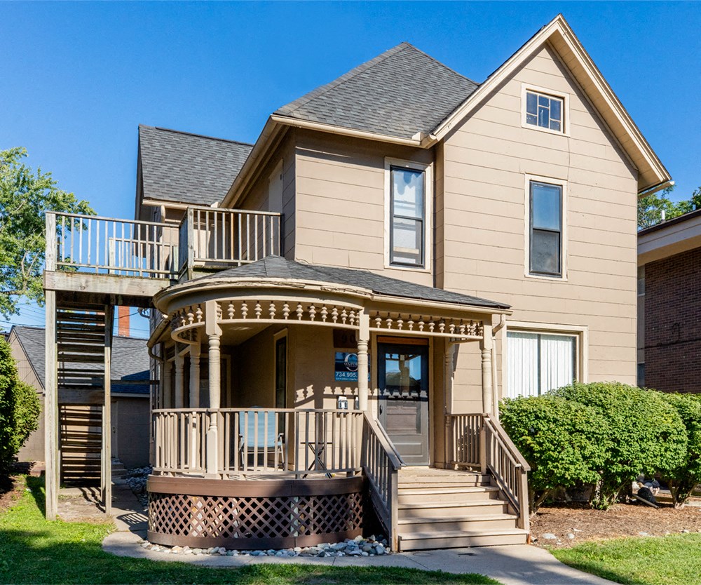the front of a house with a porch and stairs