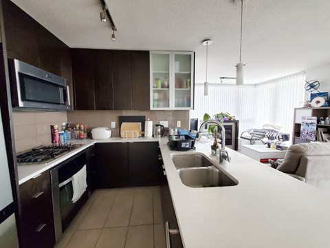 A kitchen with brown cabinets and a white counter.