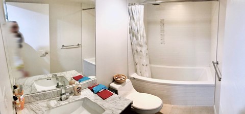 A white bathroom with a tub, toilet, and sink.
