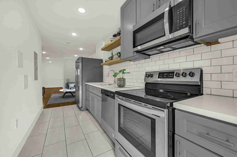 A modern kitchen with a black stove top oven.