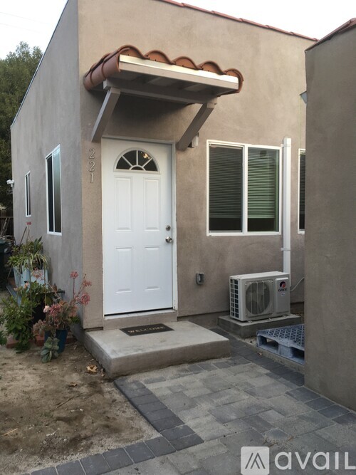 A house with a white door and a small porch.