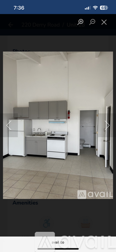 A kitchen with white appliances and grey cabinets.