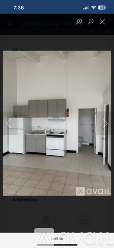 A kitchen with white appliances and grey cabinets.