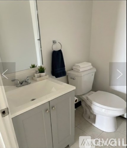 A white toilet sits next to a sink in a bathroom.