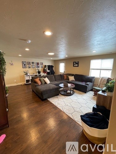A living room with a grey couch and a coffee table.