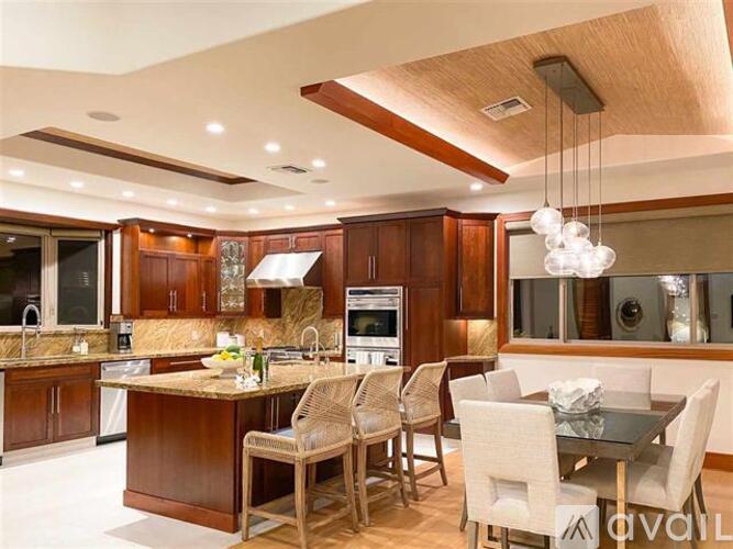 A modern kitchen with wooden cabinets and a glass table.