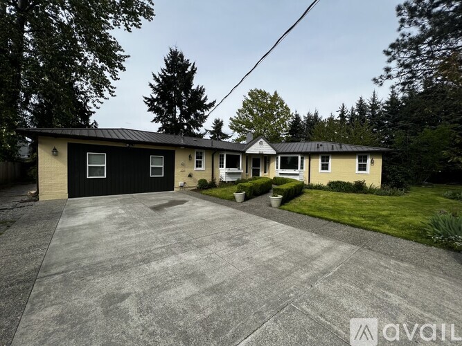 A house with a black garage door is for sale.