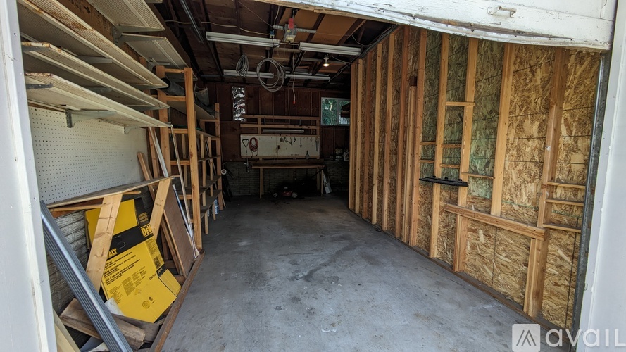A room under construction with wooden framing and insulation.