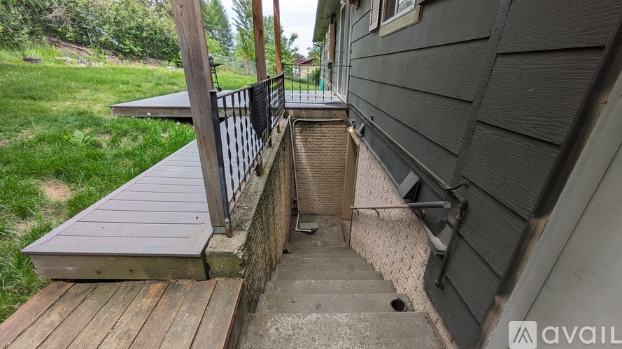 A wooden deck leads down to a stone staircase.