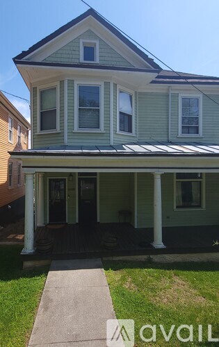 A house with a porch and a covered entrance.