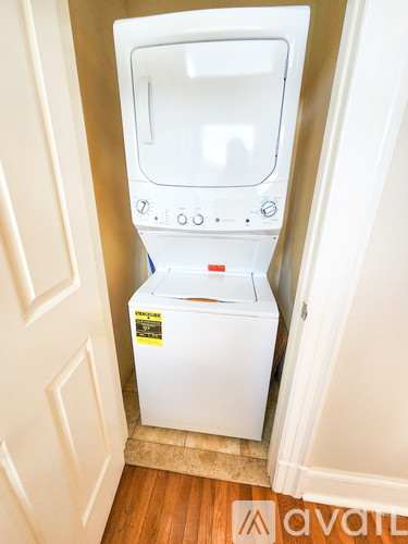 A white washing machine in a small space.