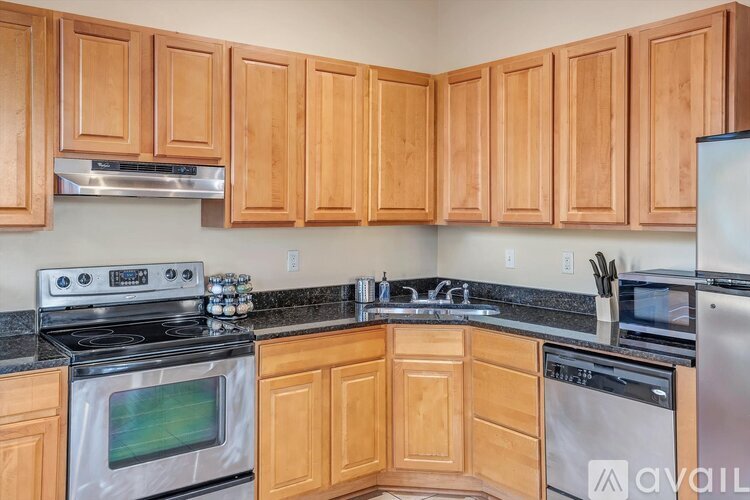 A kitchen with wooden cabinets and a black stove top.