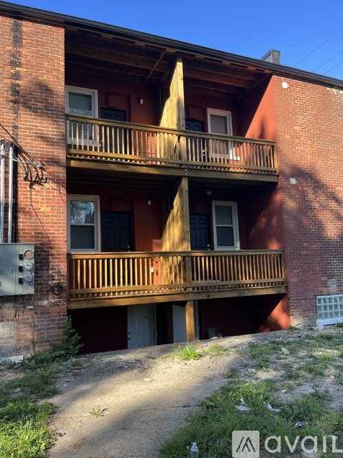 A red brick building with a wooden balcony.