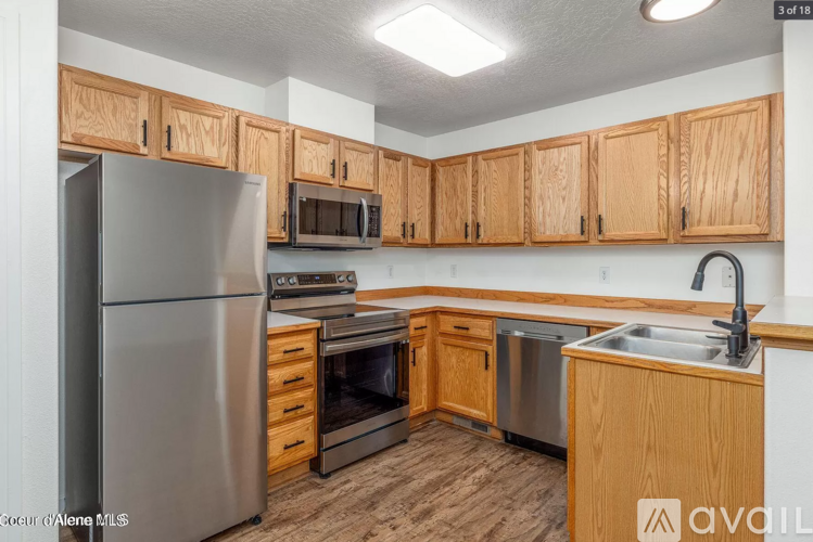 A kitchen with wooden cabinets and stainless steel appliances.