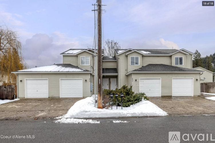 A house with a snow-covered ground in front of it.