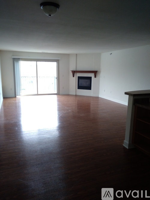 A living room with a television and sliding glass doors.