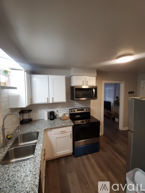 A kitchen with a sink, stove, and refrigerator.