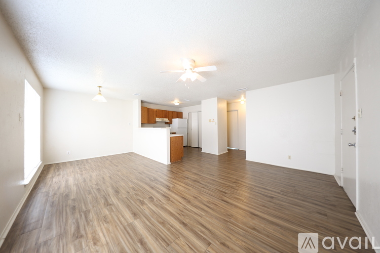 A room with wooden flooring and a white ceiling with a light fixture.