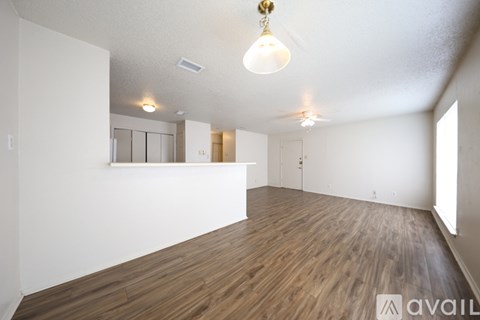 A kitchen with wooden cabinets and a white fridge.