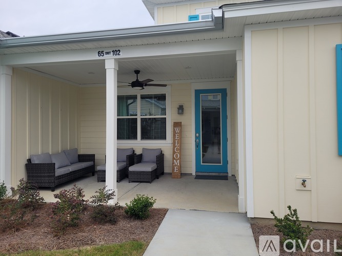 A house with a blue door and a sign that says "Welcome".