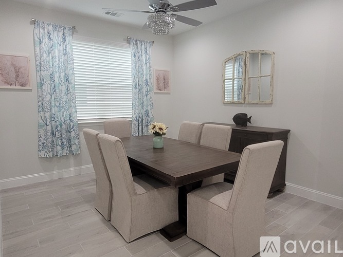 A dining room with a table and chairs.