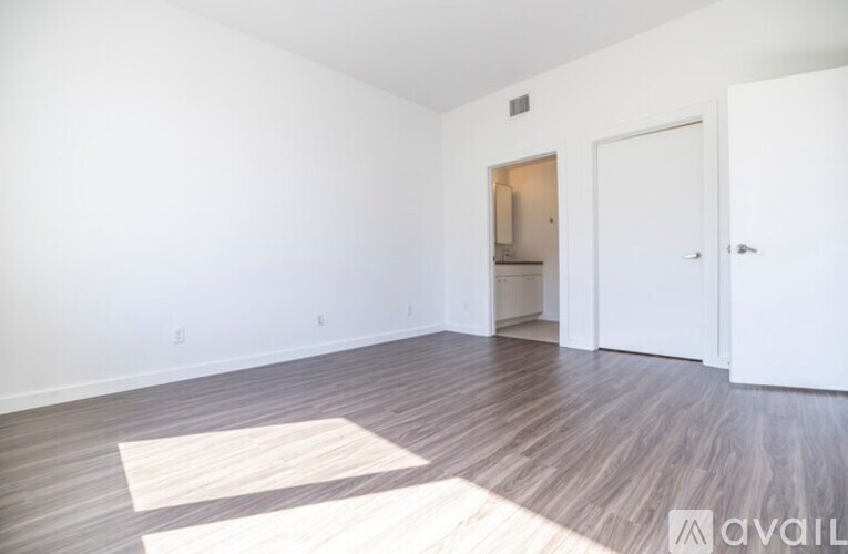 A room with a white door and a white wall.