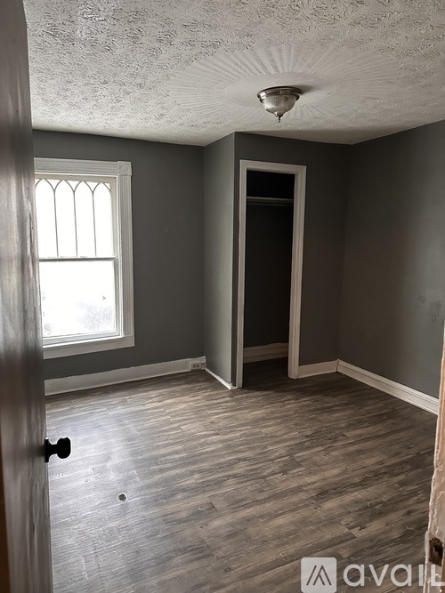 A room with a window and a door.