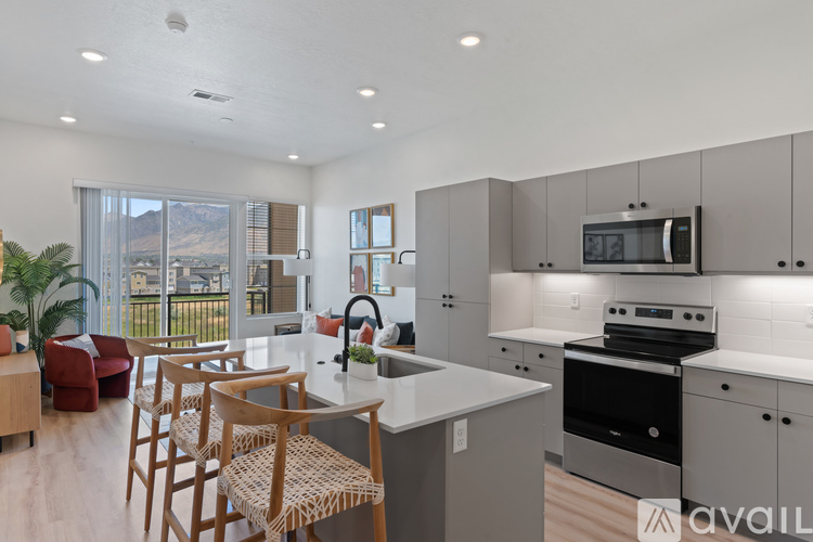 A modern kitchen with a dining table and chairs.