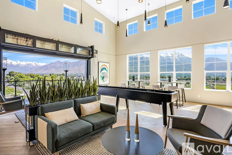 A living room with a pool table and a view of the mountains.