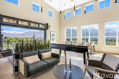 A living room with a pool table and a view of the mountains.