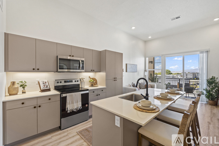 A modern kitchen with a dining table set for two.