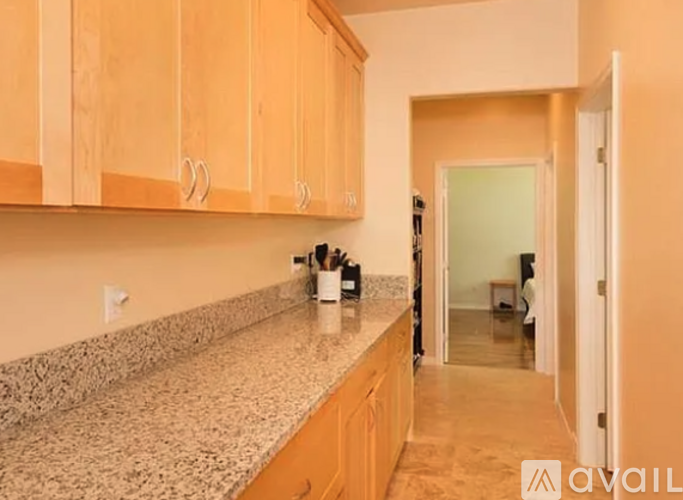 A kitchen with wooden cabinets and a granite countertop.