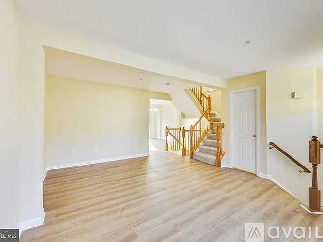 A spacious room with a staircase leading to the upper floor.
