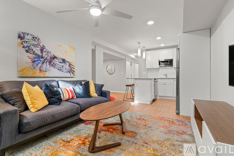 A living room with a grey couch and a wooden coffee table.
