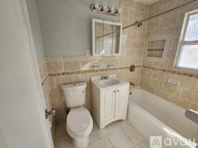 A bathroom with a toilet, sink, and tub.