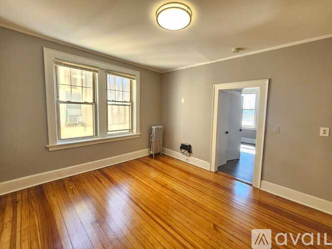 A room with wooden floors and a window.