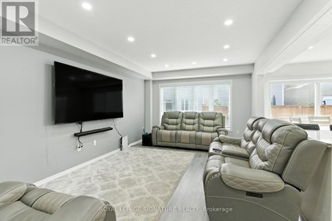 A living room with a row of leather sofas and a television.