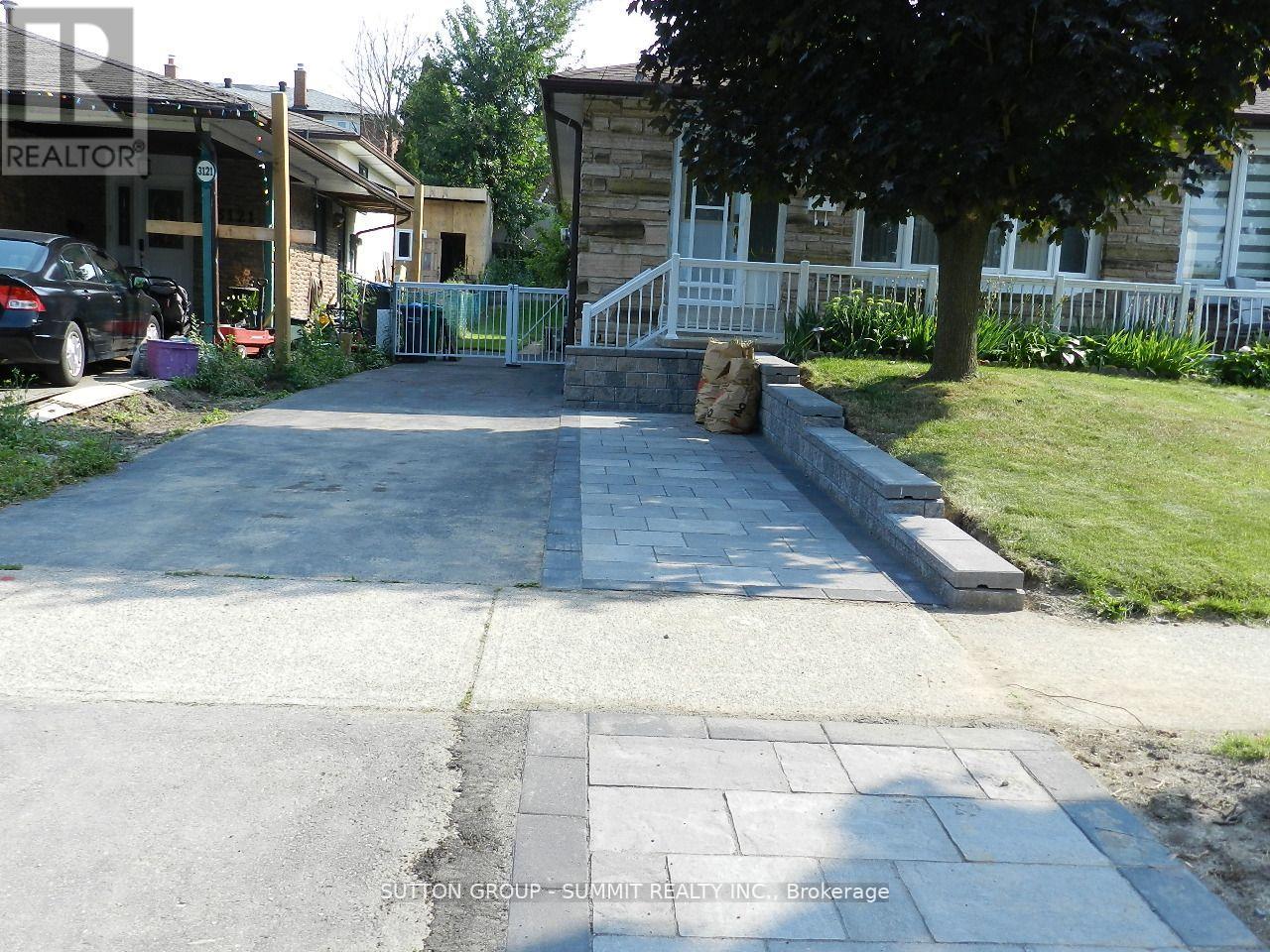 A residential street with a car parked on the side.
