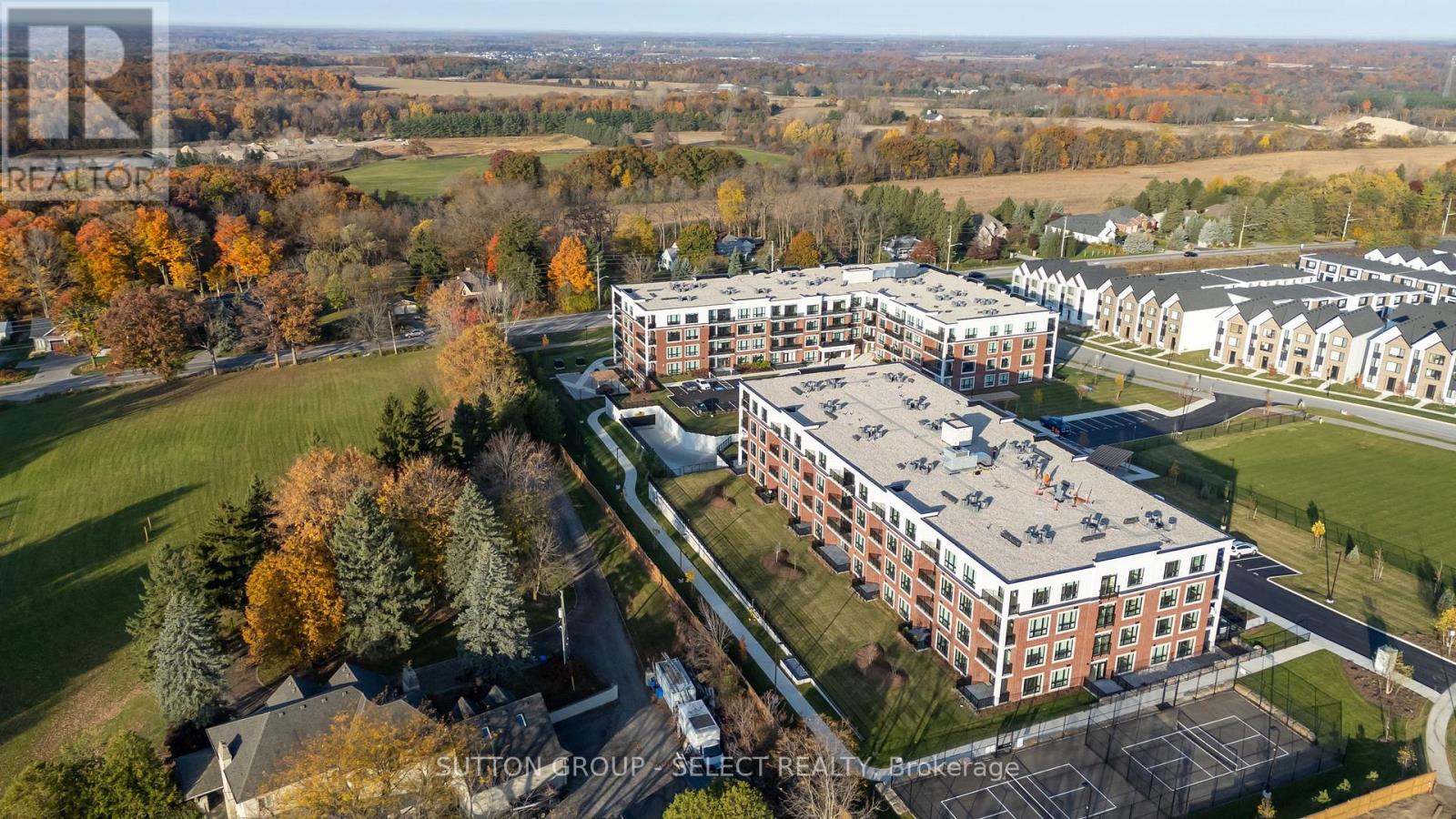 An aerial view of a large building complex surrounded by trees.