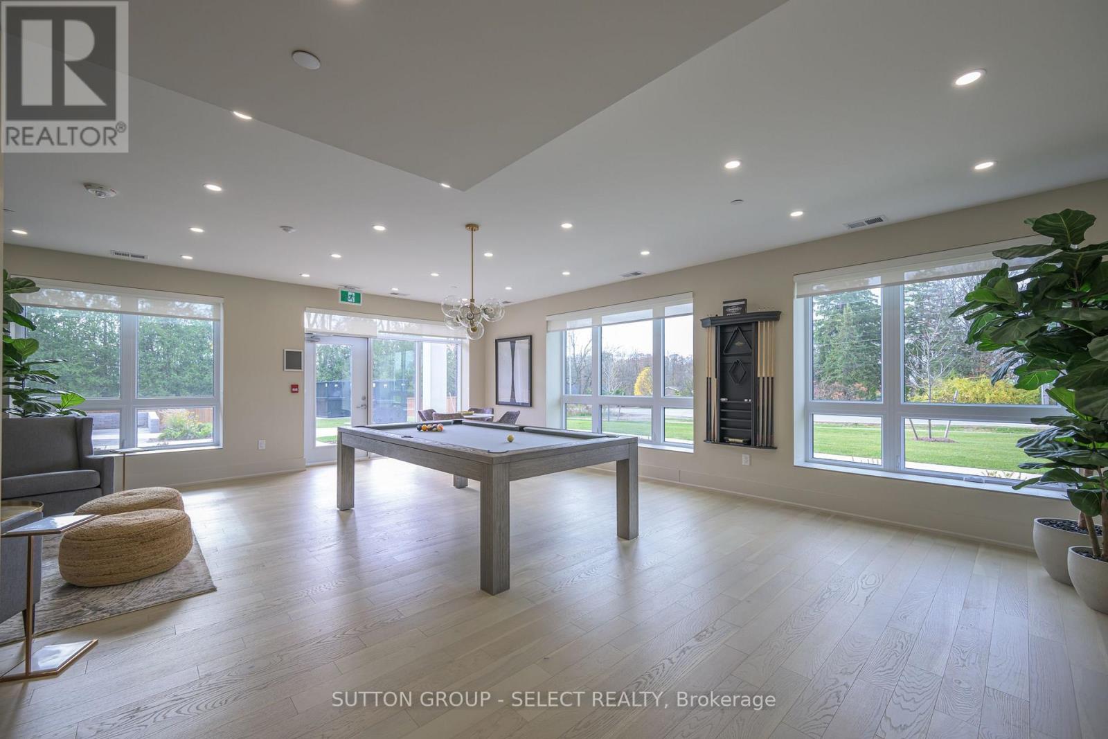 A spacious room with a pool table and a view of the outdoors.