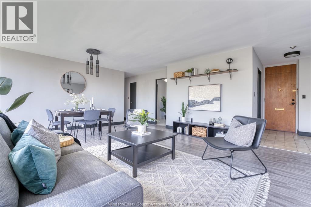 A modern living room with a grey sofa and a glass coffee table.