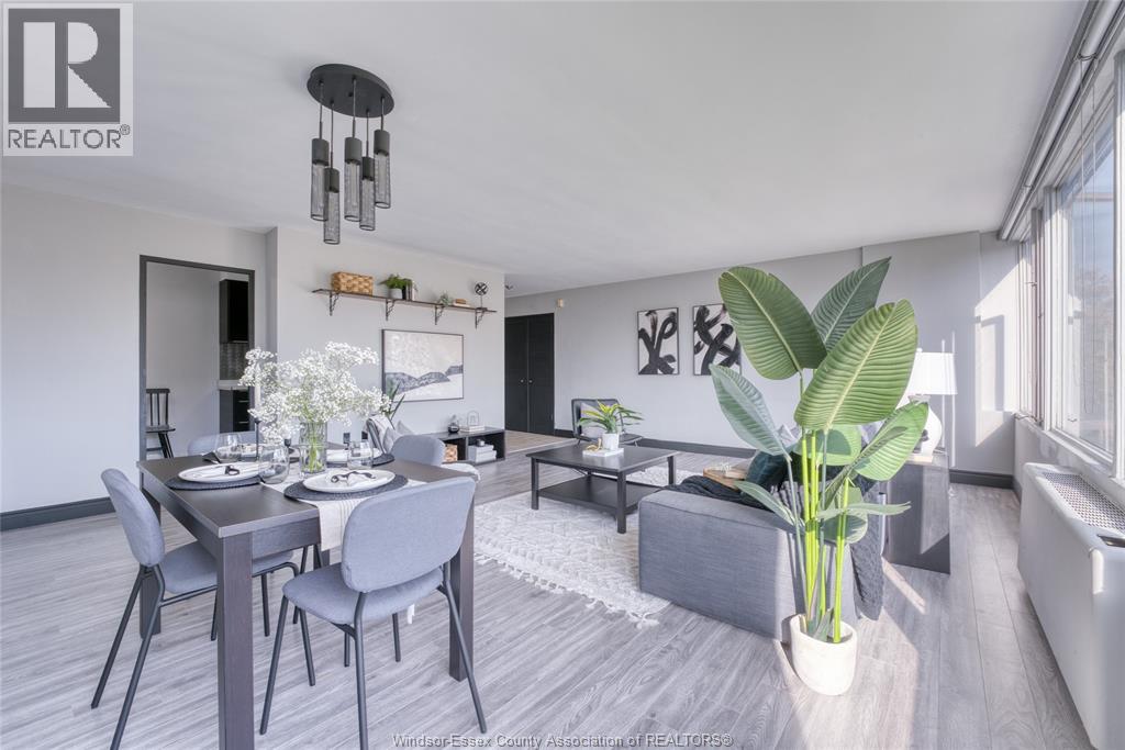 A modern dining room with a large table and chairs.