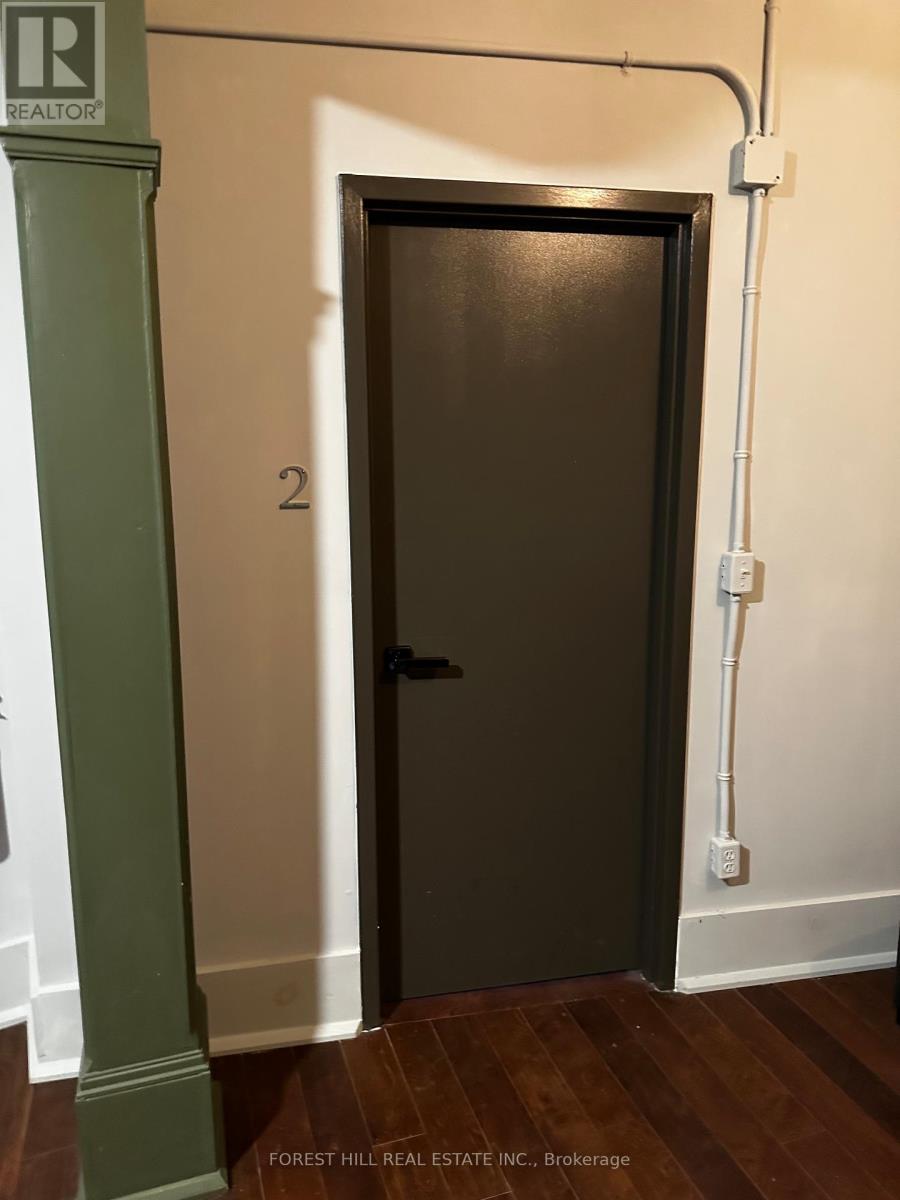 A door with a number 2 on it is in a hallway.