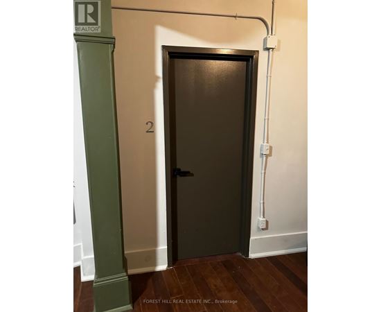 A door with a number 2 on it is in a hallway.