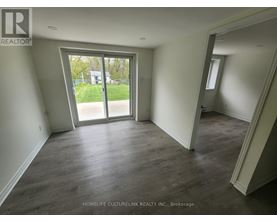A room with a sliding glass door leading to a backyard.