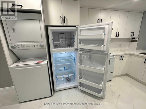A white refrigerator with its door open in a kitchen.